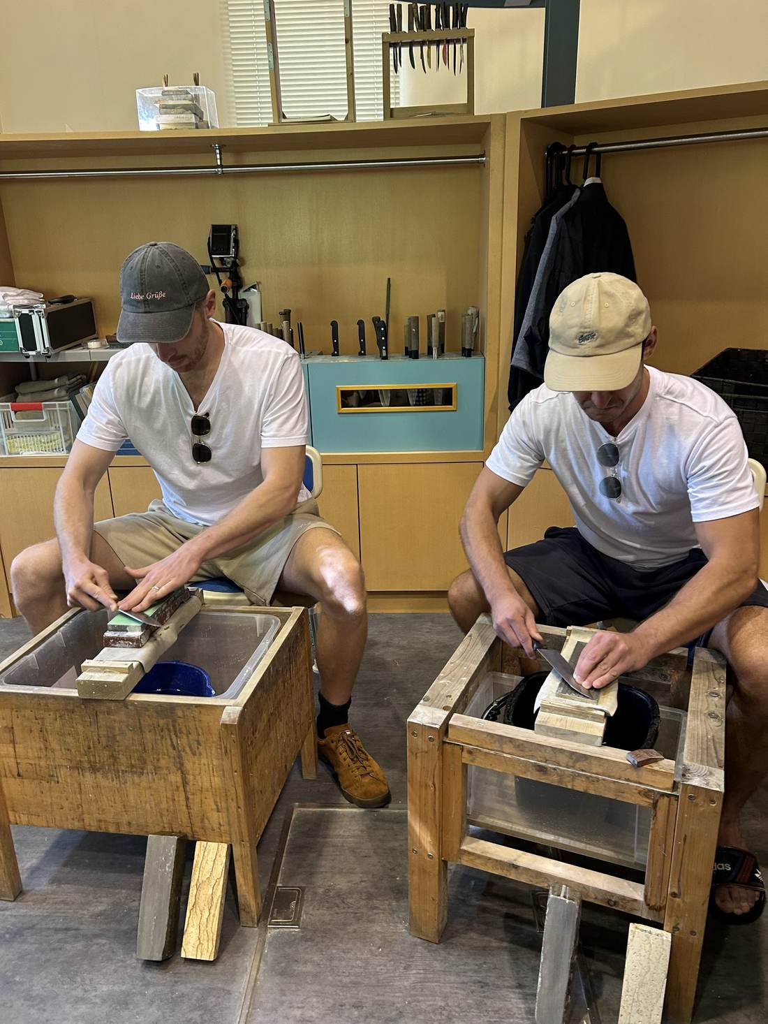 Sharpening Japanese knives on water stones in a Kameoka workshop