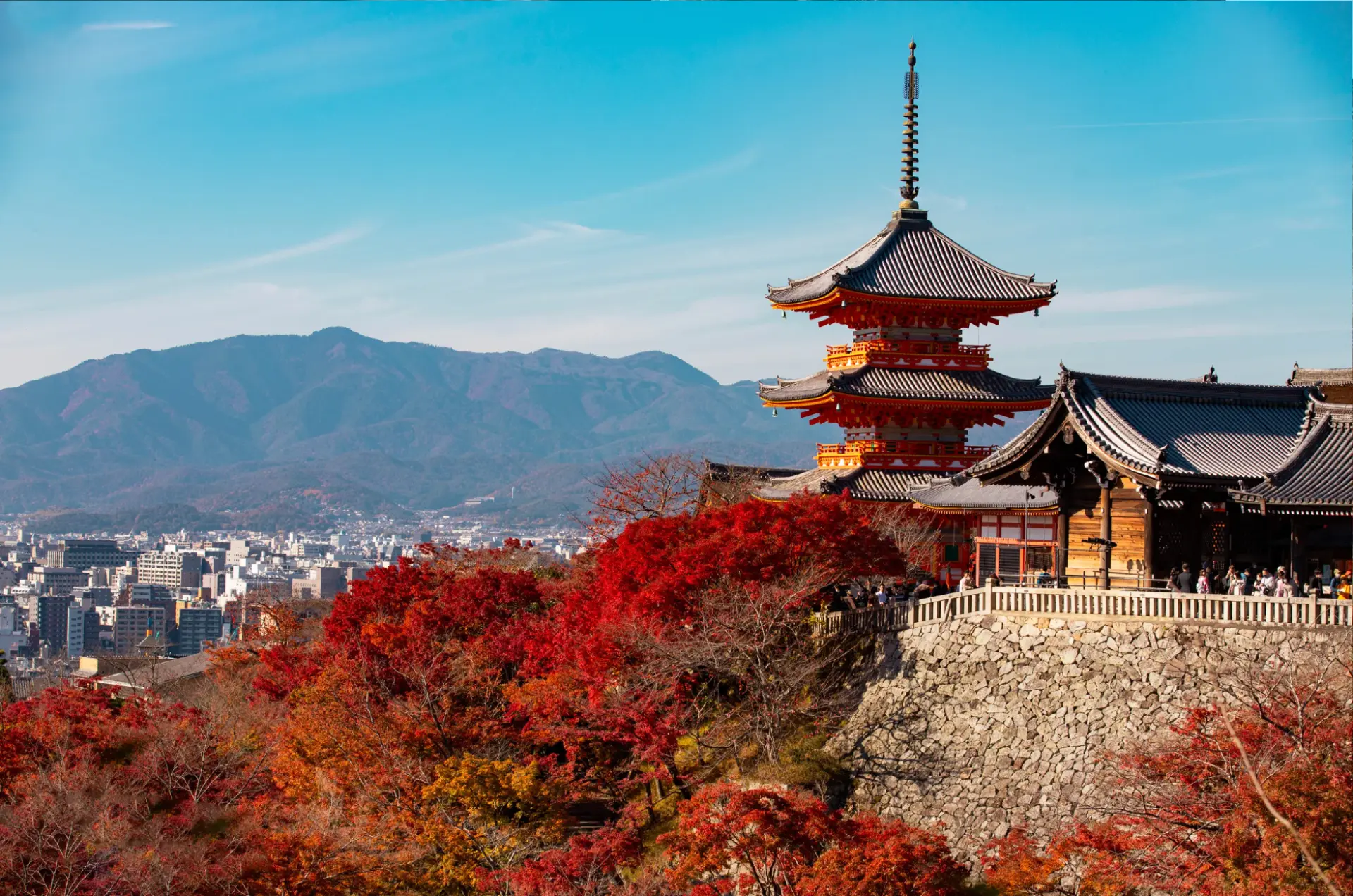 Kiyomizu-dera pagoda above Kyoto in full autumn colour, with the mountains behind the city