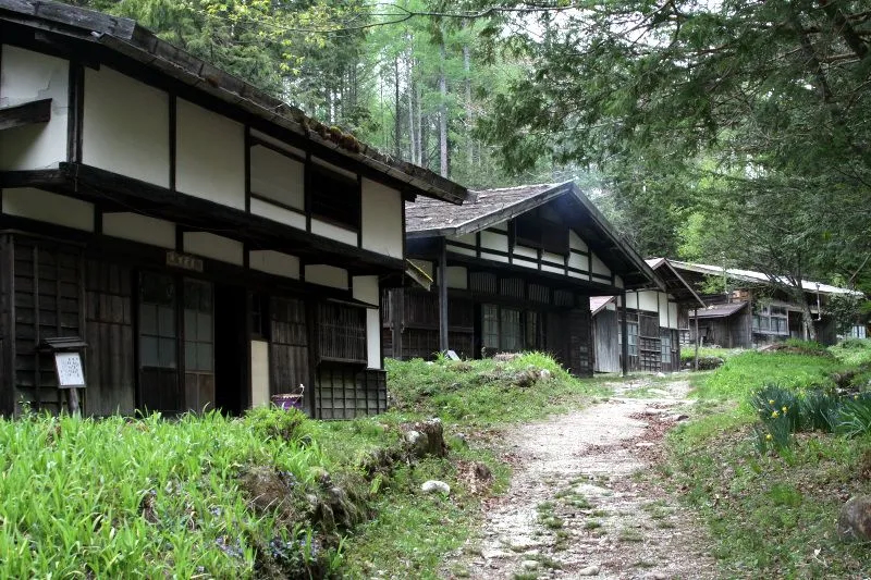 Nagano — historic wooden farmhouses along a forest path in Oodaira