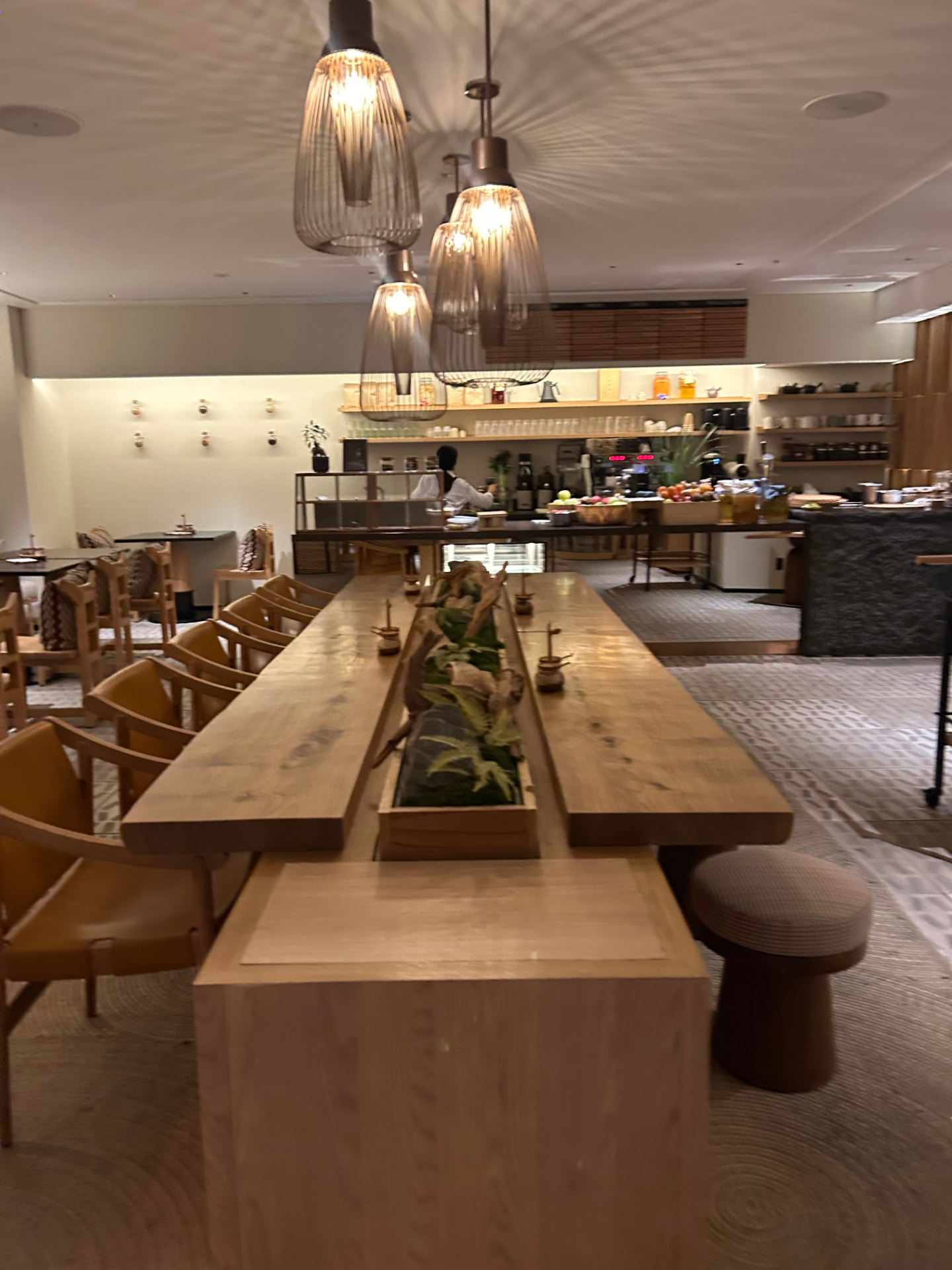 Private chef's table dinner in a warmly lit contemporary Kyoto dining room